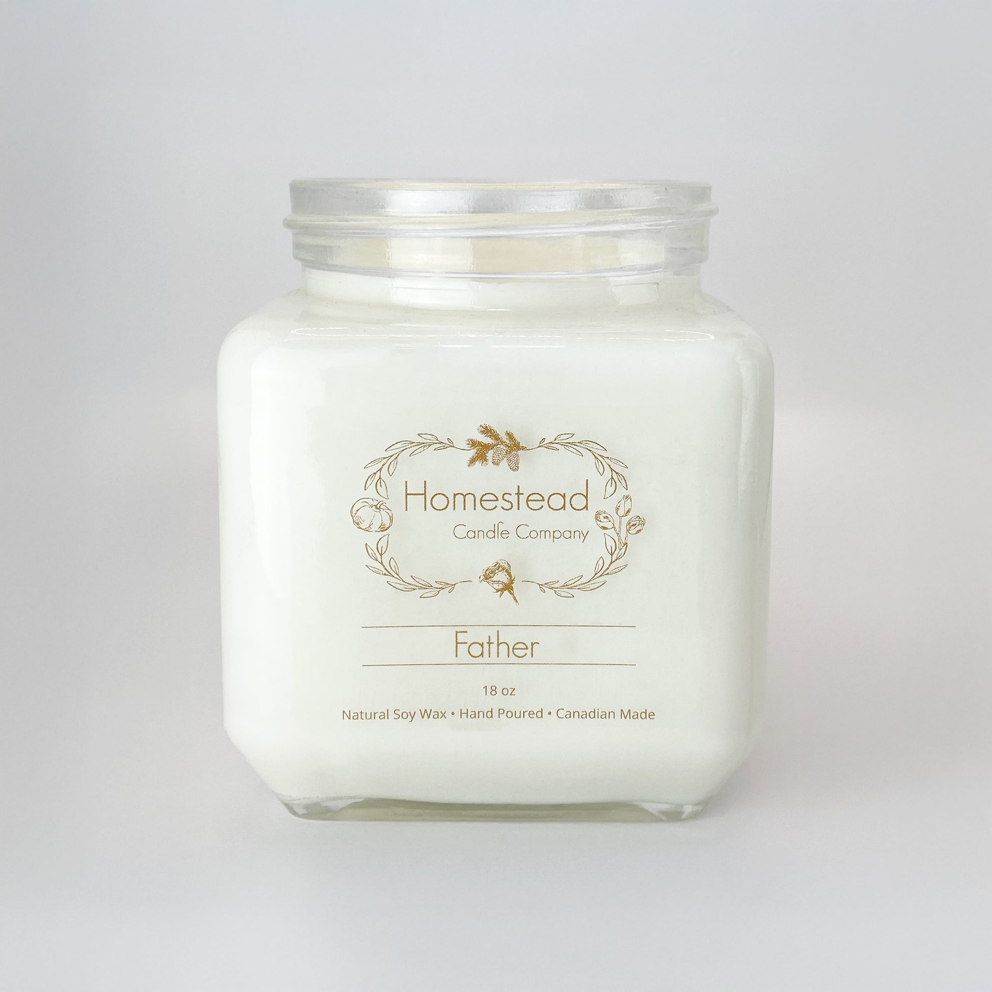 Father's Day Soy Candle Gift in the scent of Sandalwood. White background with a cube clear glass candle jar. Label is transparent with brown lettering.